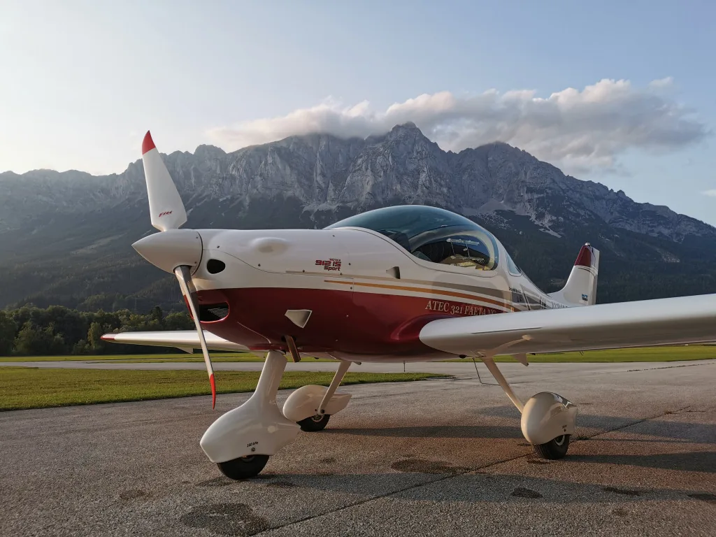 ATEC 321 Faeta NG parked in front of mountains